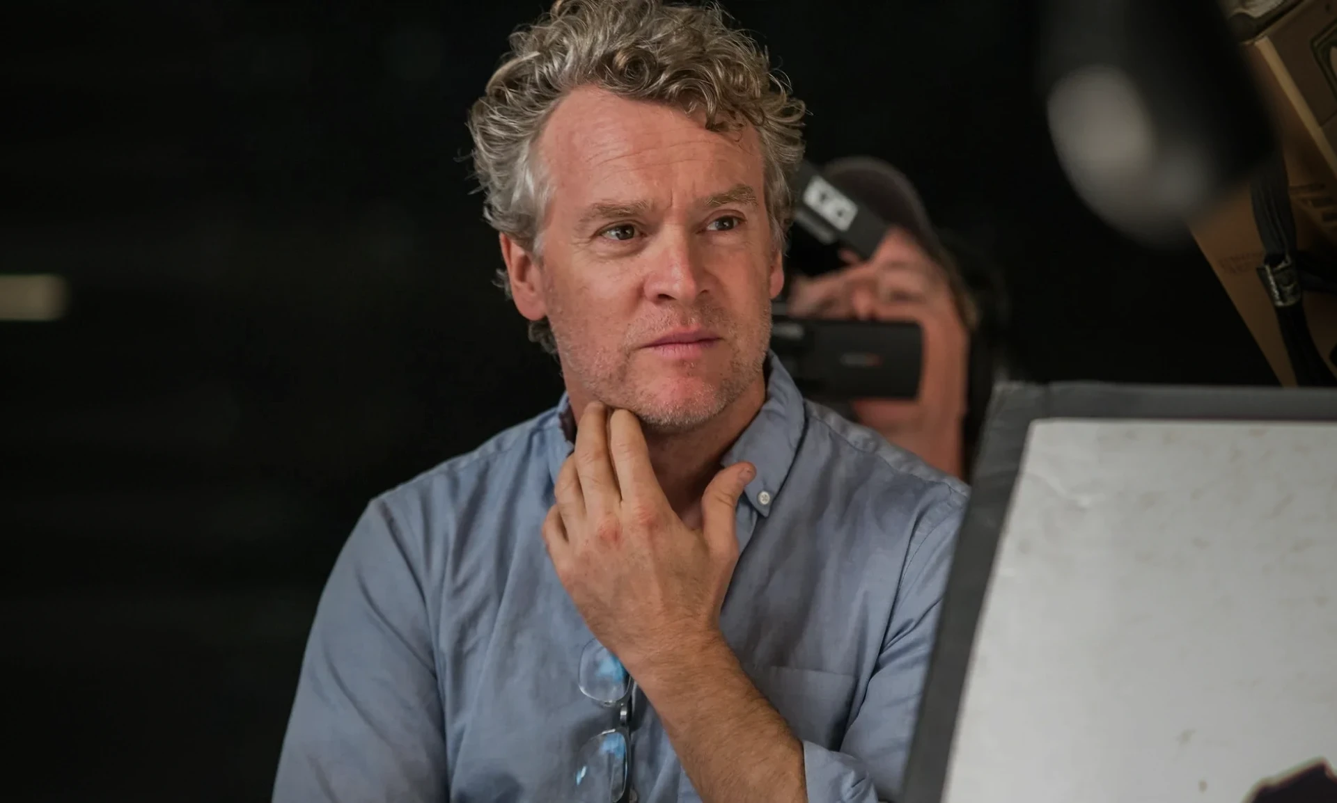 Director observing with thoughtful expression