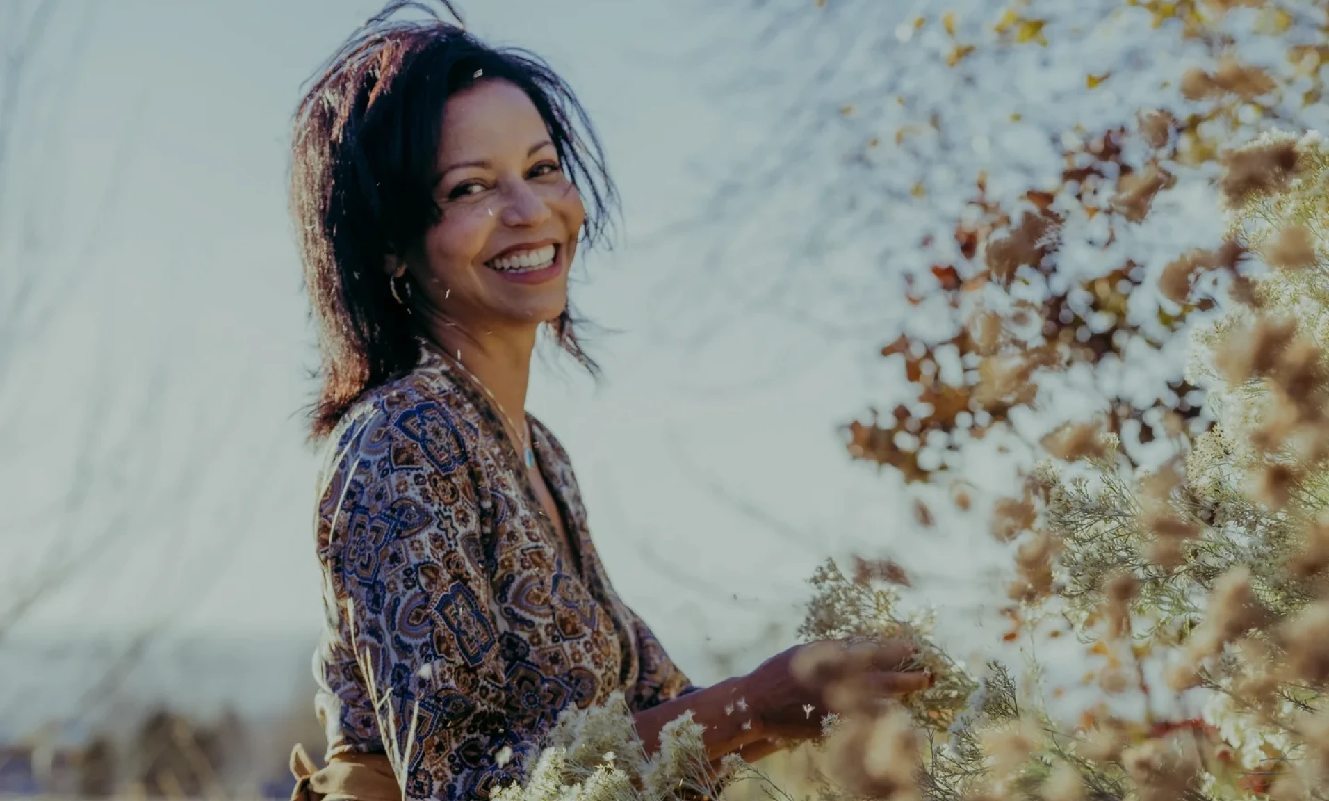 Joyful person in floral dress outside